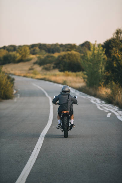 istock A biker rides a cafe racer on the highway 2161467738