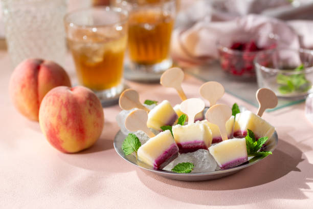 istock Homemade raspberries and peach popsicles 2161467769