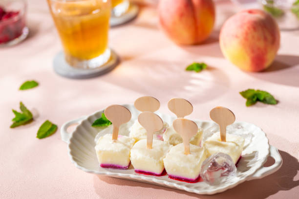 Homemade raspberries and peach popsicles