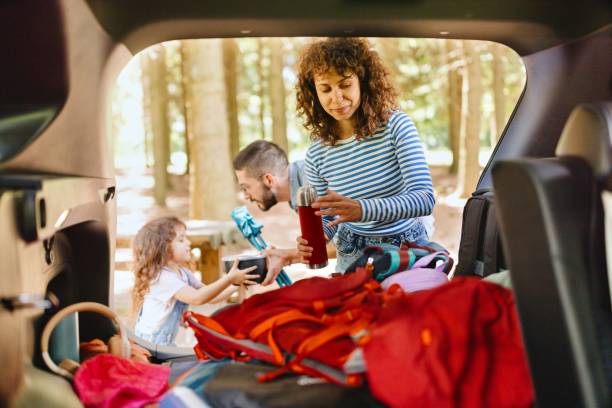 istock Mother unpacking camping gear from the car 2161468313