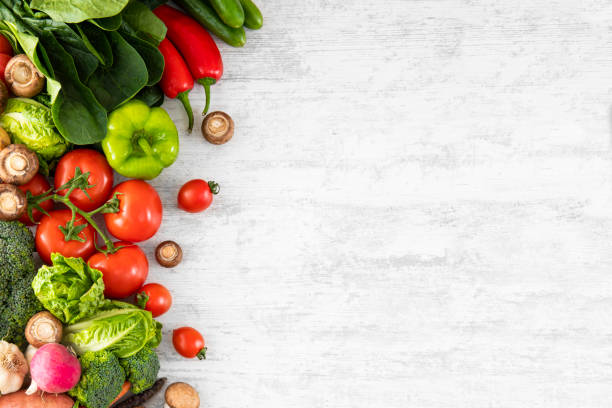 istock Fresh Vegetables on White Wooden Table Background 2161469084