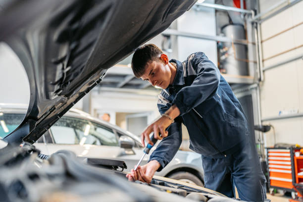 istock Young Car Mechanic Working On A Car In His Garage 2161470224