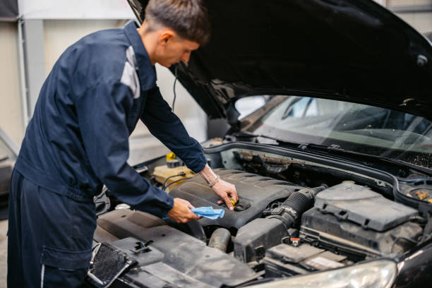 istock Young Car Mechanic Working On A Car In His Garage 2161471707
