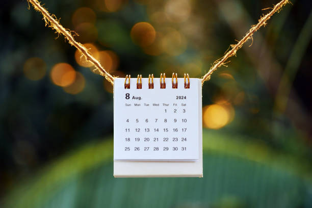 istock August 2024 desk calendar on a string with sunset bokeh background 2161477800