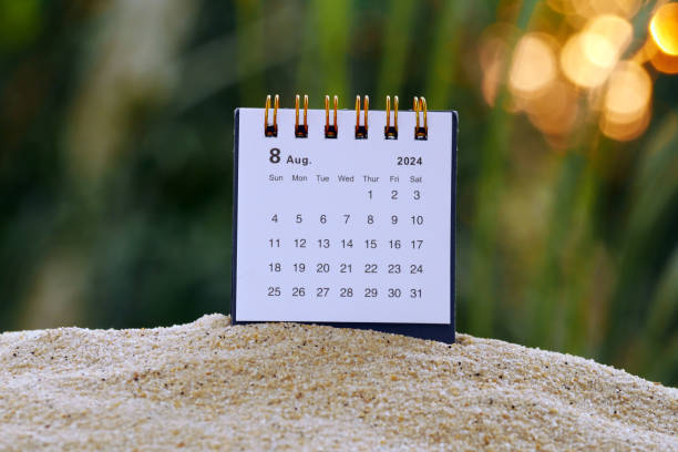 istock August 2024 desk calendar on beach sand with sunset bokeh background 2161477847
