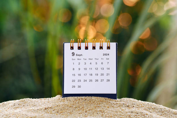 istock September 2024 desk calendar on beach sand with sunset bokeh background 2161477869