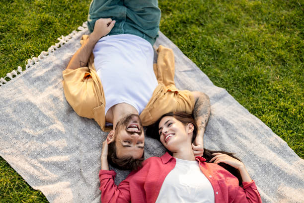 istock Couple relaxing on a blanket in a green park. 2161478023