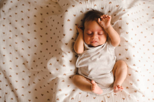 istock Baby boy in bed at home 2161478124
