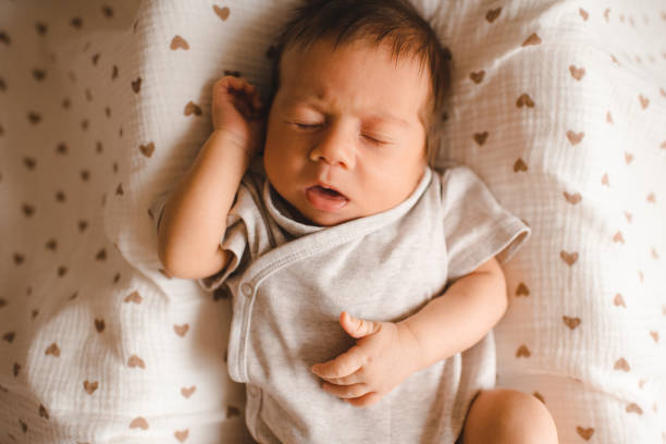 istock Baby boy in bed at home 2161478141