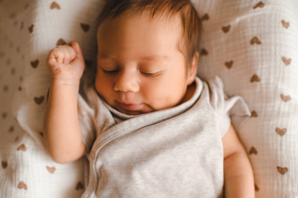 istock Baby boy in bed at home 2161478156