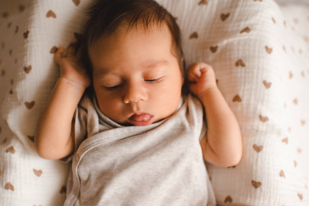 istock Baby boy in bed at home 2161478157