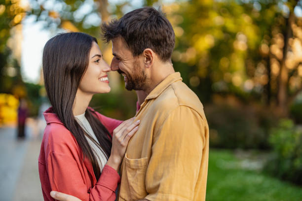 istock Romantic couple sharing a quiet embrace in the park. 2161478343