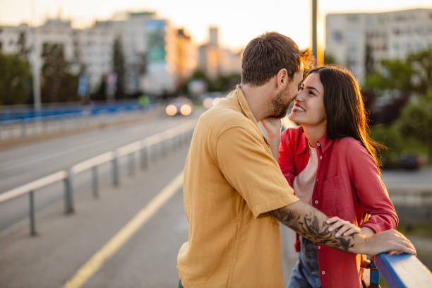 istock Happy couple resting foreheads together at sunset 2161478665