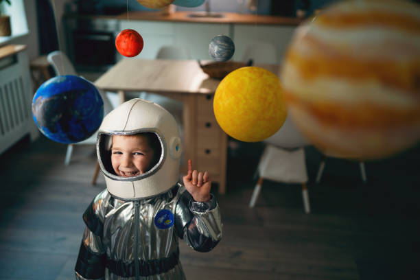 istock Preschool boy in a space suit playing at home, imagining space travel. 2161479183