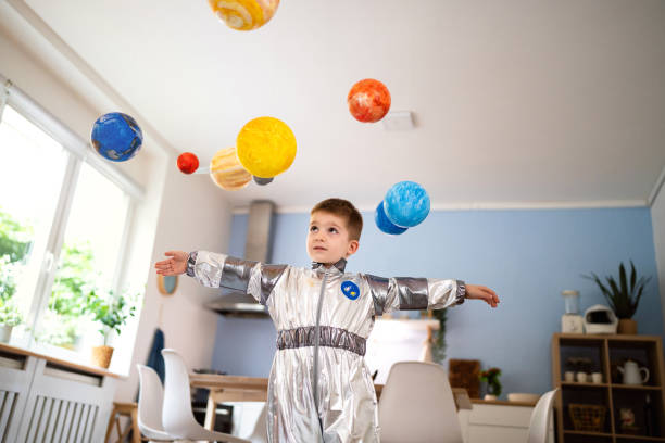 istock Preschool boy in a space suit playing at home, imagining space travel. 2161479200