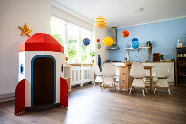 istock Cardboard rocket ship and wall hanging solar system at the modern apartment 2161481439