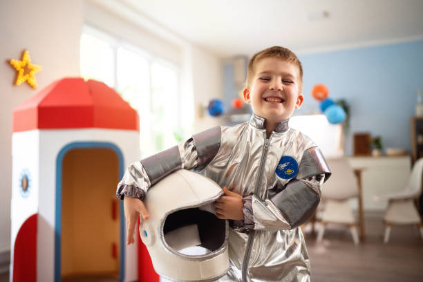 istock Smiling boy in a space suit playing at home, imagining space travel. 2161481750