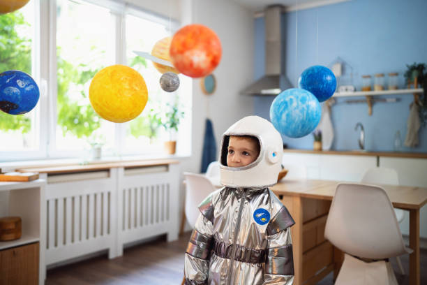 istock Boy in a space suit playing at home, imagining space travel. 2161483689