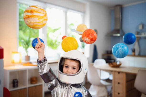 istock Boy in a space suit playing at home, imagining space travel. 2161483715