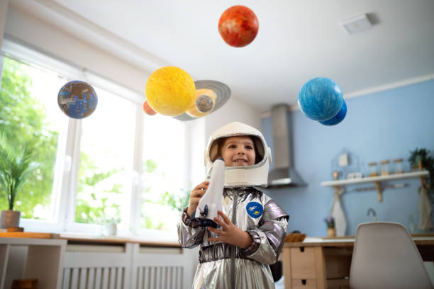 istock Boy in a space suit playing at home, imagining space travel. 2161484468