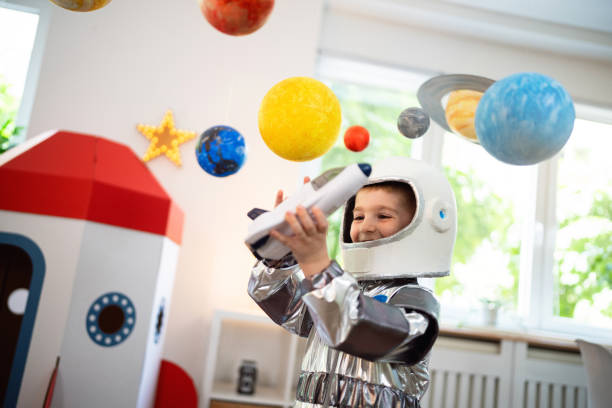 istock Boy in a space suit playing at home, imagining space travel. 2161484469