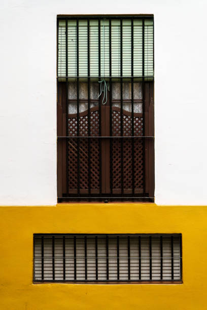 istock A traditional spanish window with wooden shutters and iron bars 2161486758