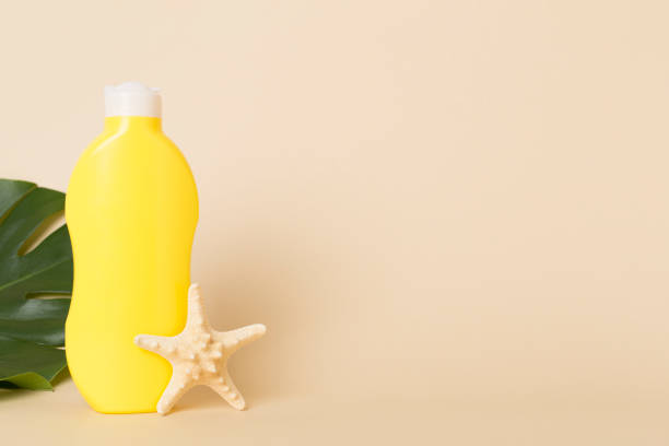 istock Sunscreen lotion with summer decor on table against color background 2161488284