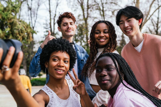 istock Diverse friends taking a fun selfie outdoors in a park with lush greenery. 2161488902