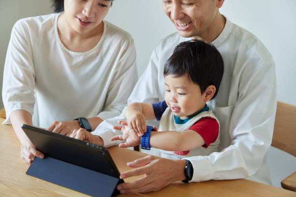 istock Children and parents play with computers and smartwatches 2161490757
