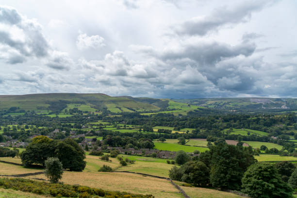 istock Pastoral Panorama: A Lush Green Landscape Under a Dynamic Sky 2161492288