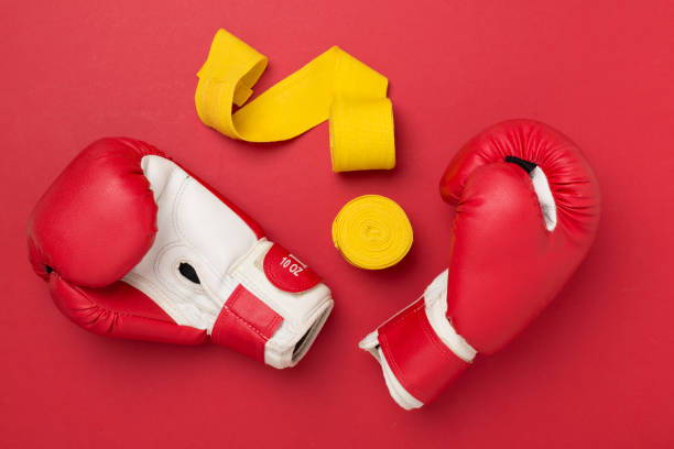 istock Red boxing gloves on color background, top view. 2161493721
