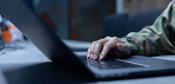 istock close up soldier man hand typing on keyboard laptop to check and use command for military operation test system in office room concept 2161496843