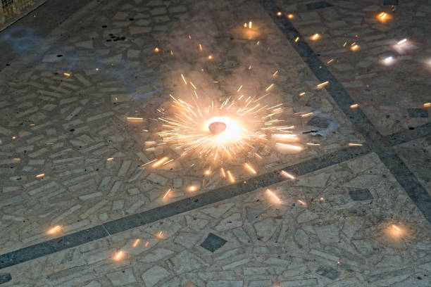 Party is over. Textured abstract backgrounds. Golden background with lit sparkler.