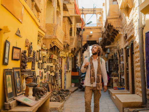 Man exploring Jaisalmer old town inside fort with gift shops and old architecture