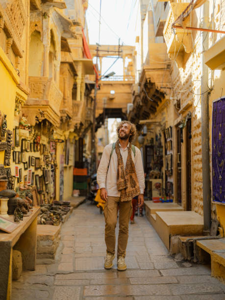 istock Man exploring Jaisalmer old town inside fort with gift shops and old architecture 2161497273