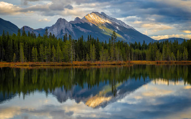 istock Calm lake reflecting majestic mountain peak at sunset 2161498104