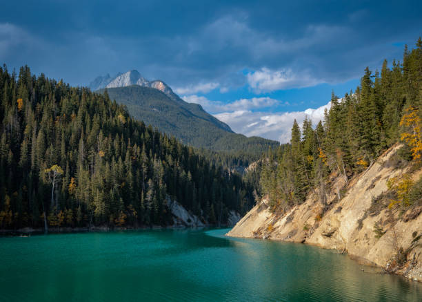 istock Turquoise lake water surrounded by mountain forest landscape 2161498340