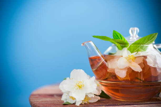 jasmine flower tea in a glass teapot .