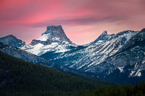 istock Dramatic pink sunset illuminating snow capped mountain peaks 2161498796