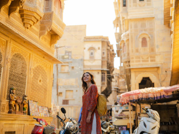 Woman walking on crowded street in old town of Jaisalmer, India Cheerful woman walking on crowded street in old town of Jaisalmer, India indian wedding stock pictures, royalty-free photos & images