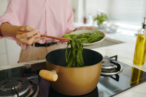 istock Woman Boiling Greens In Pan 2161502954