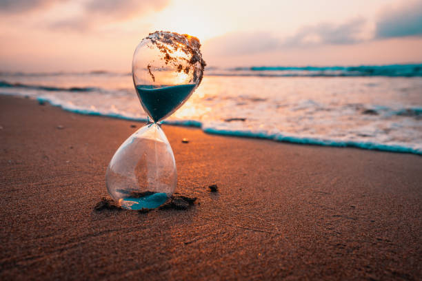 istock Sunset or sunrise, hourglass on the seashore 2161506150