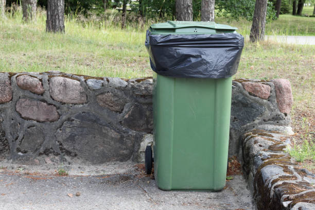istock .garbage can with a black bag on the street 2161506834
