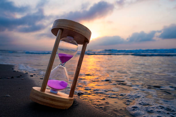 istock Sunset or sunrise, hourglass on the seashore 2161506888
