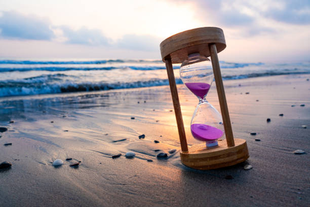istock Sunset or sunrise, hourglass on the seashore 2161507086