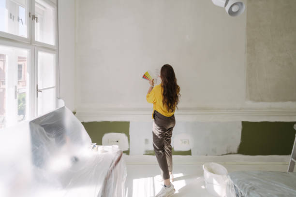 istock Choosing a wall paint shade from a colour swatch 2161507219