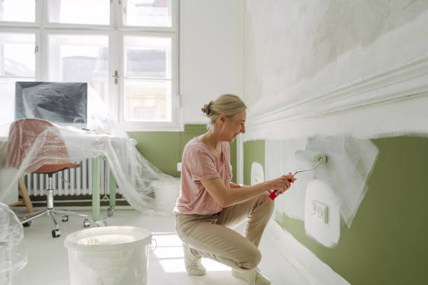 istock DIY: A woman's painting her own apartment 2161507234