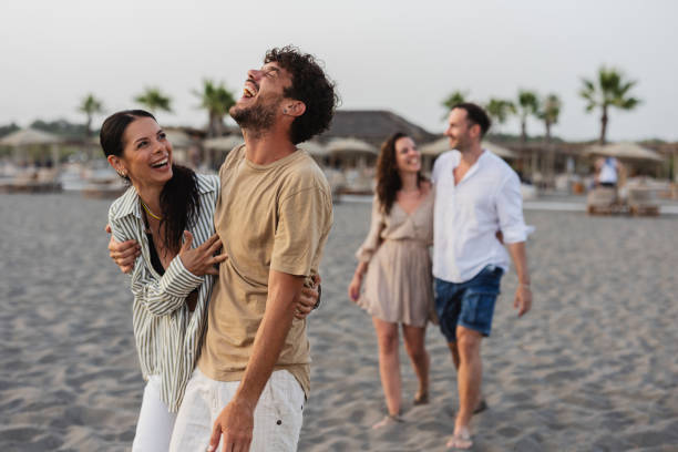 istock Friends Laughing and Walking on the Beach 2161515755