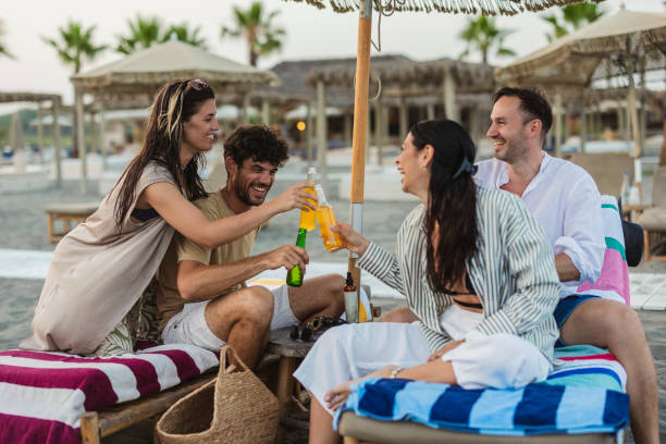 istock Friends Toasting Drinks Under Beach Umbrella 2161515810