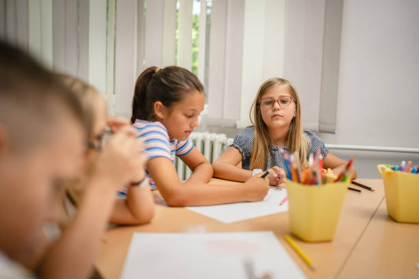 Young students paint and draw on class in the classroom